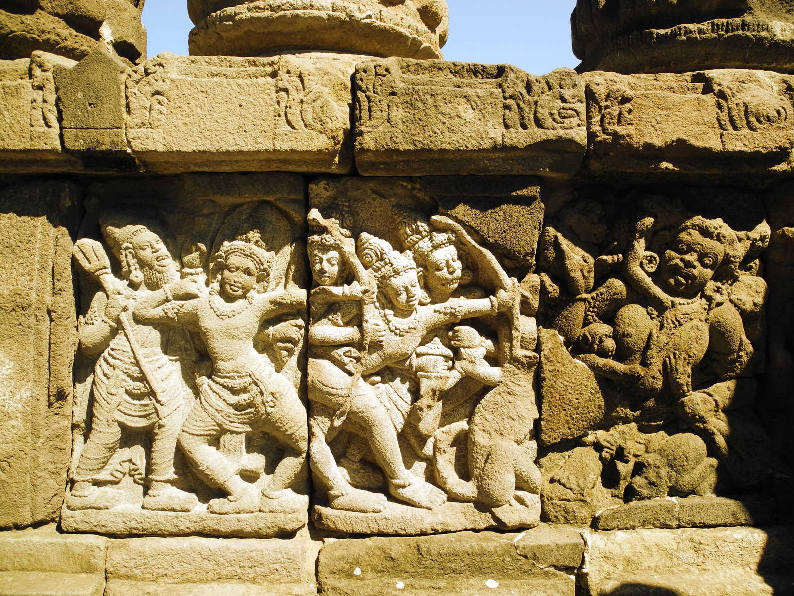 stone carving showing indian deities holding arms out