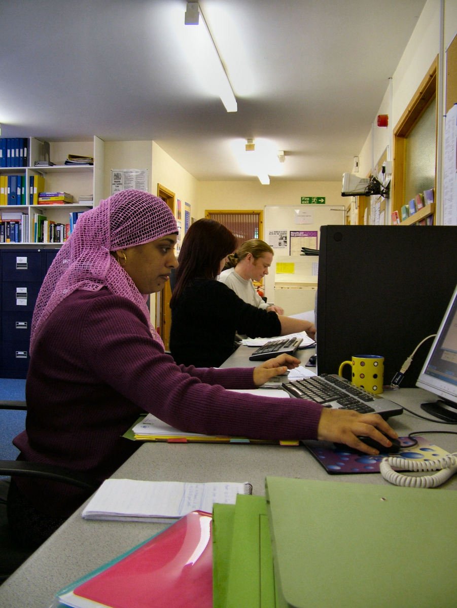 two people working on their laptop computers in a liry