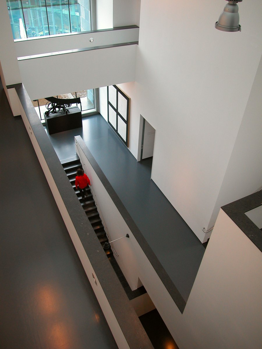 a modern office has a staircase with red flowers on it