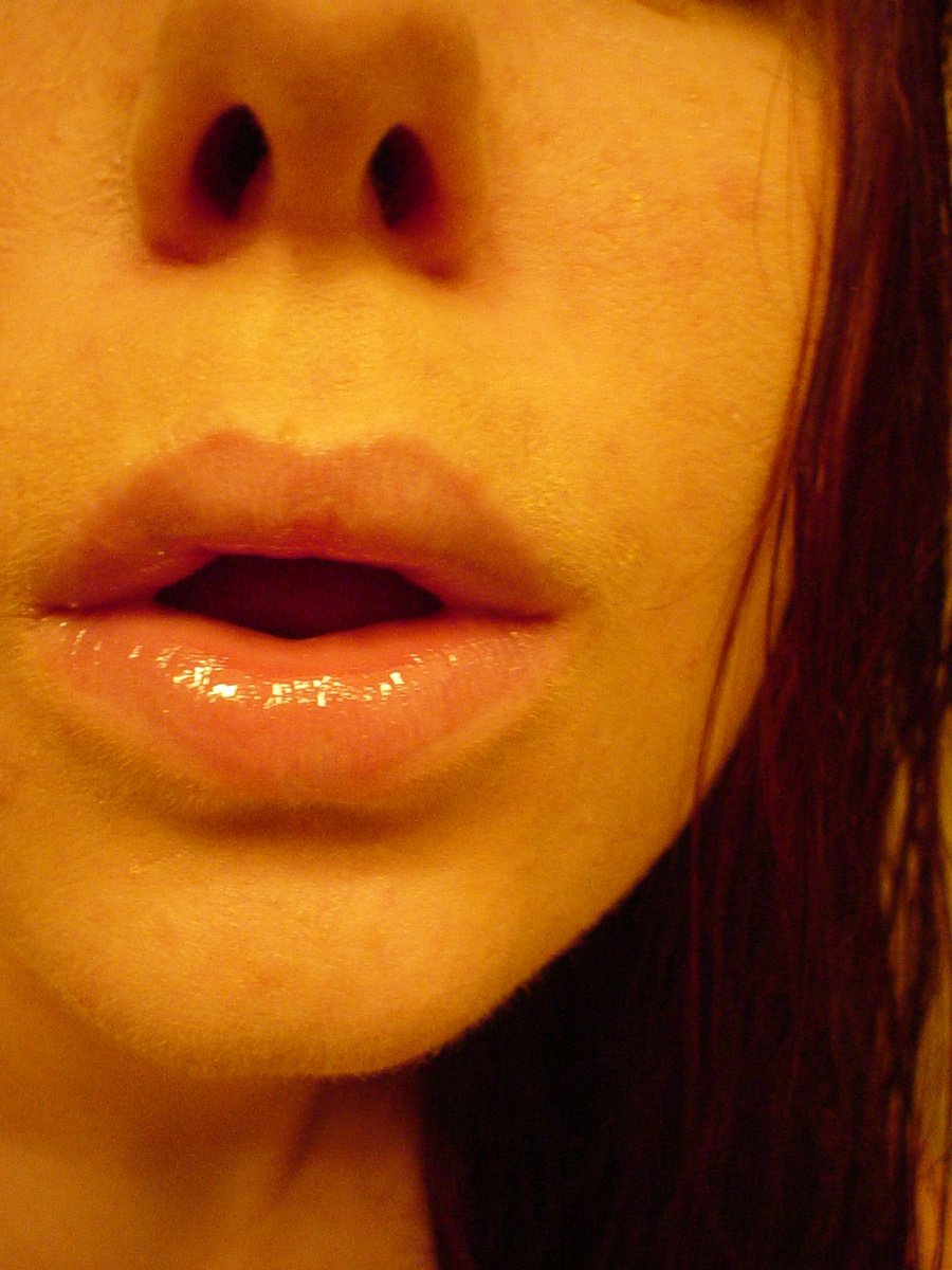 a closeup view of a womans lip as she looks straight ahead