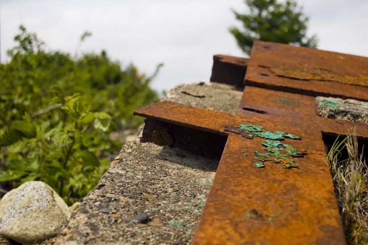 rusted crosses at the top of an old hill