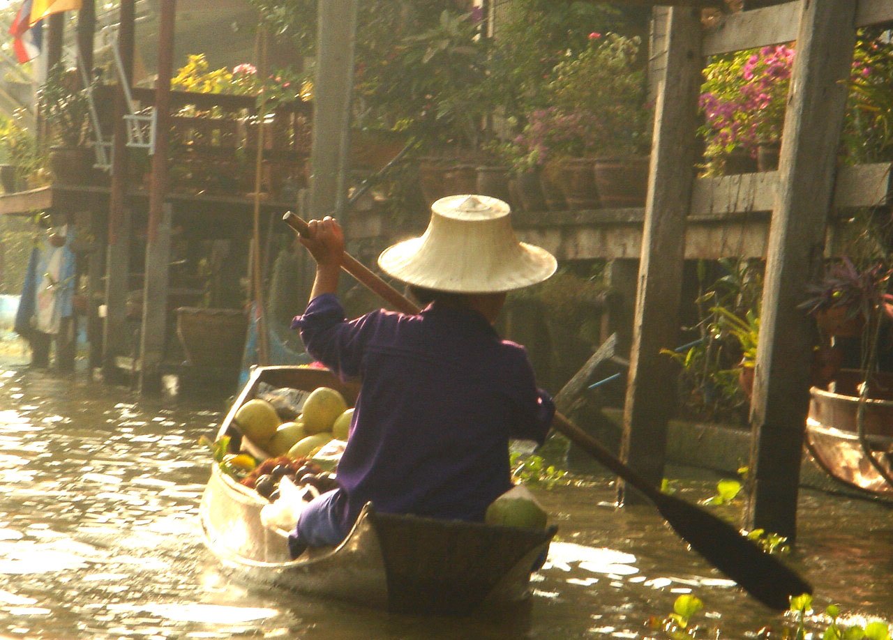 a person in a white hat is riding on a boat