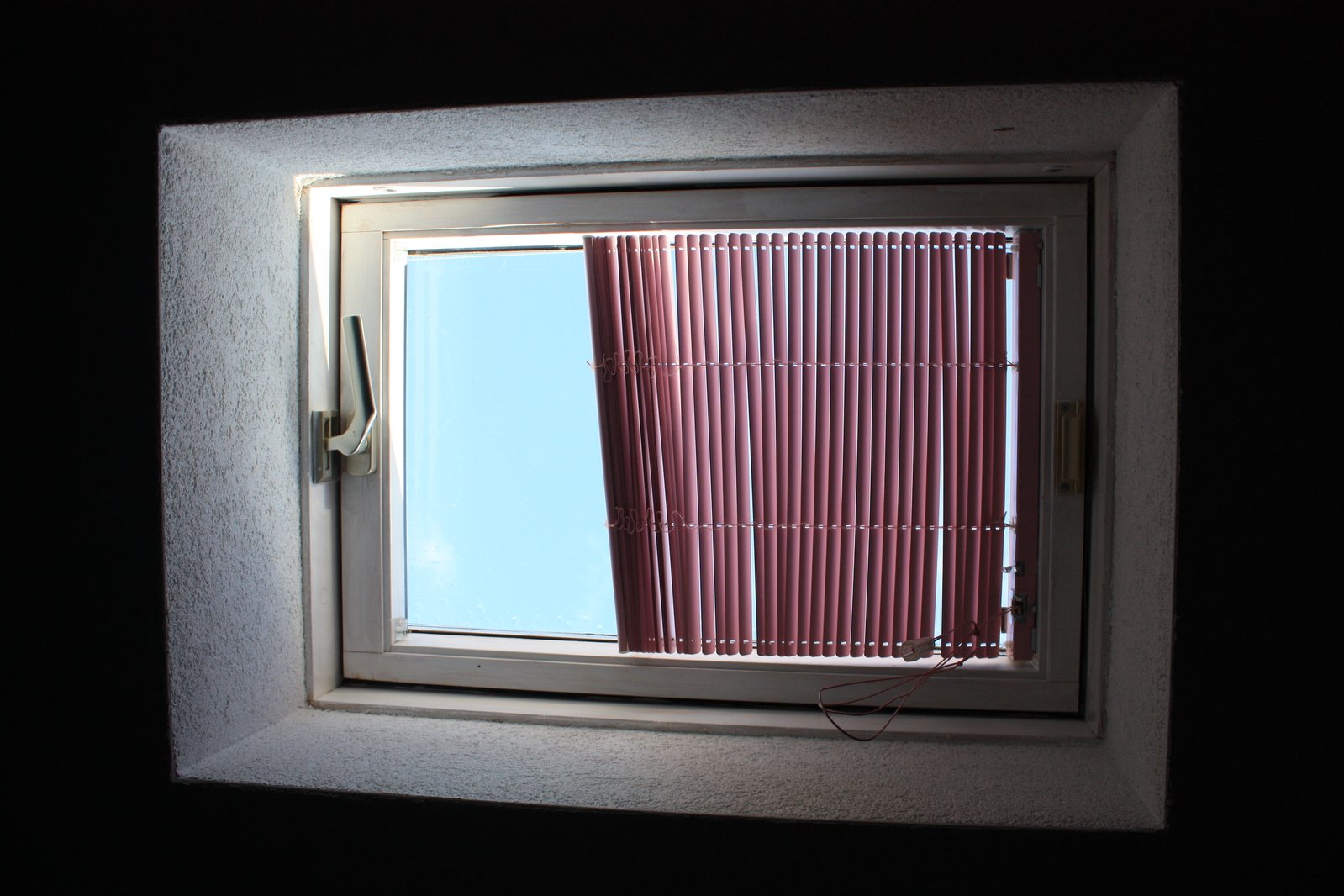 the view through a window that shows a pair of scissors on the floor