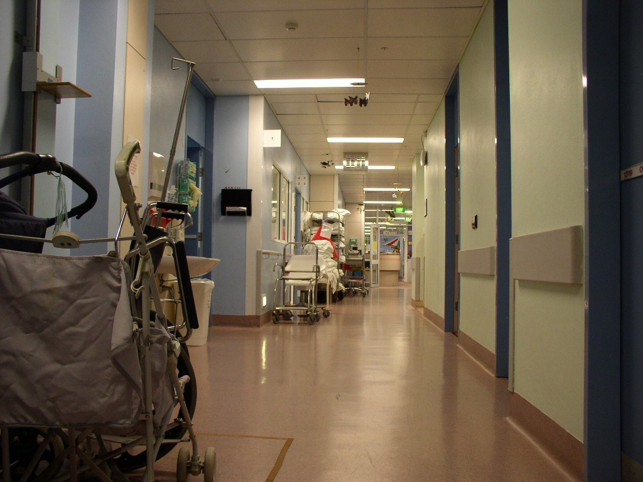 a medical hallway with empty chairs and medical equipment