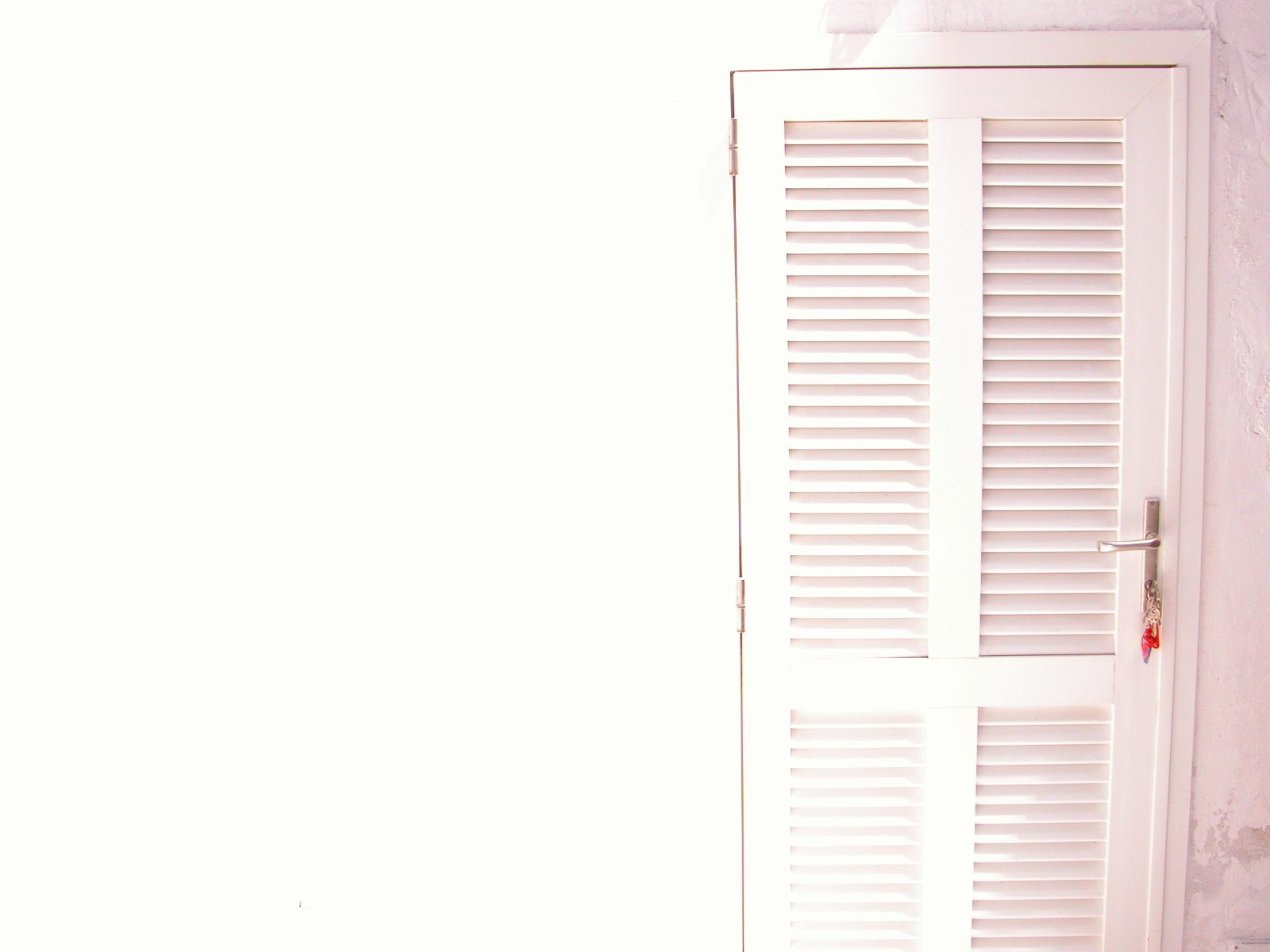 the inside of a white door in a small room