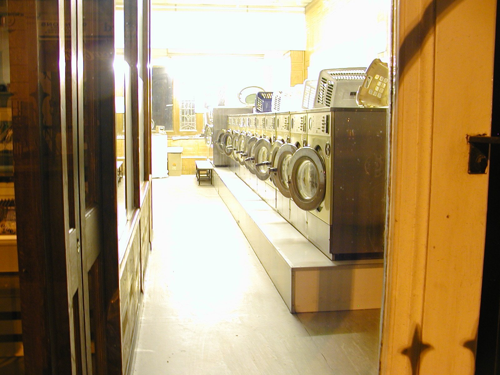 the front door of a laundry station with a row of washers sitting in it