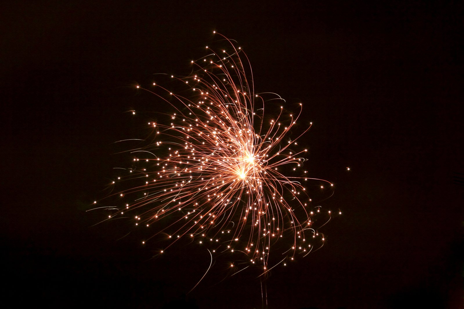 colorful fireworks at night with a building in the background