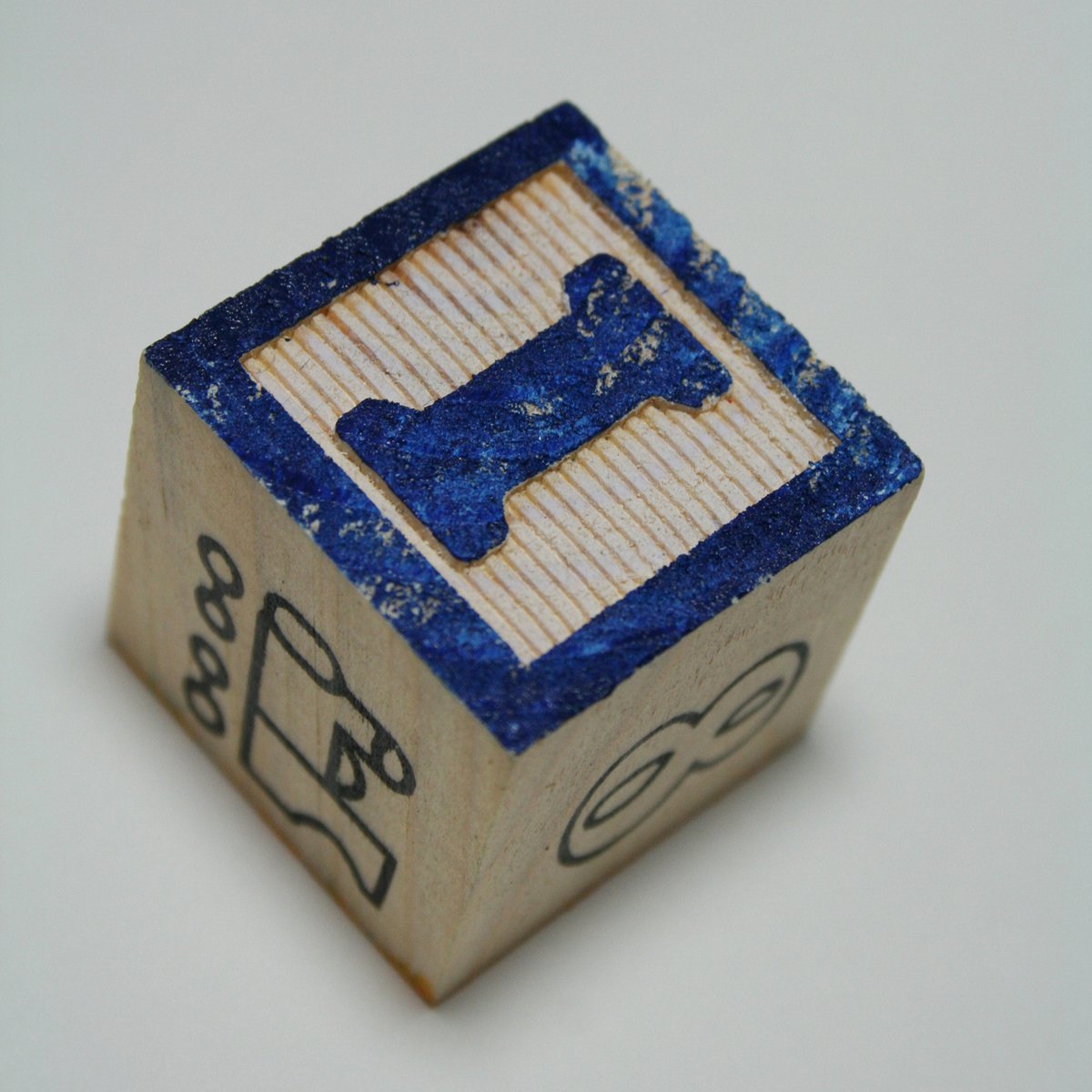 a wooden dice sitting on top of a white surface