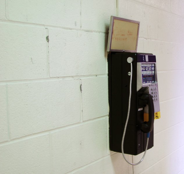 a old cell phone on the wall next to a charger