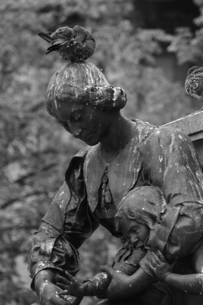 an angel statue in a black and white po