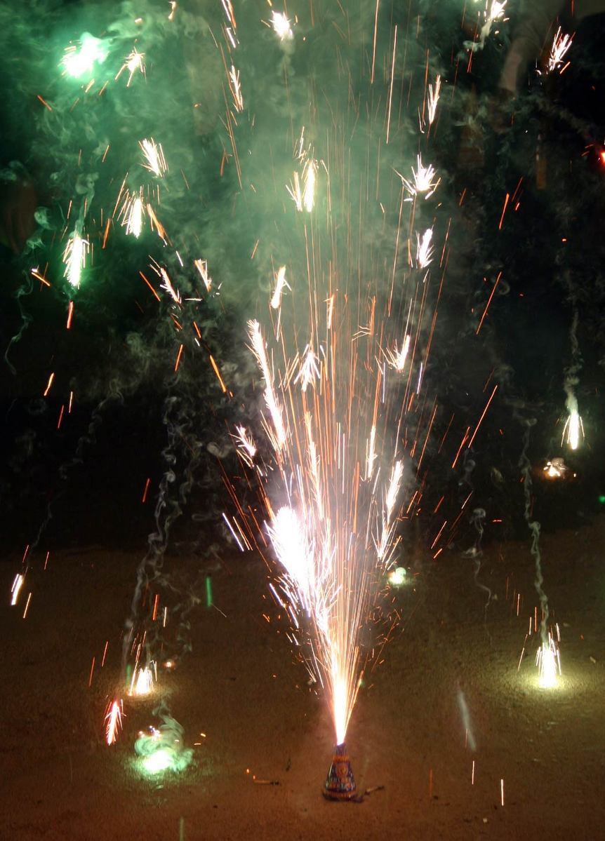 a small boy is holding onto some big sparklers