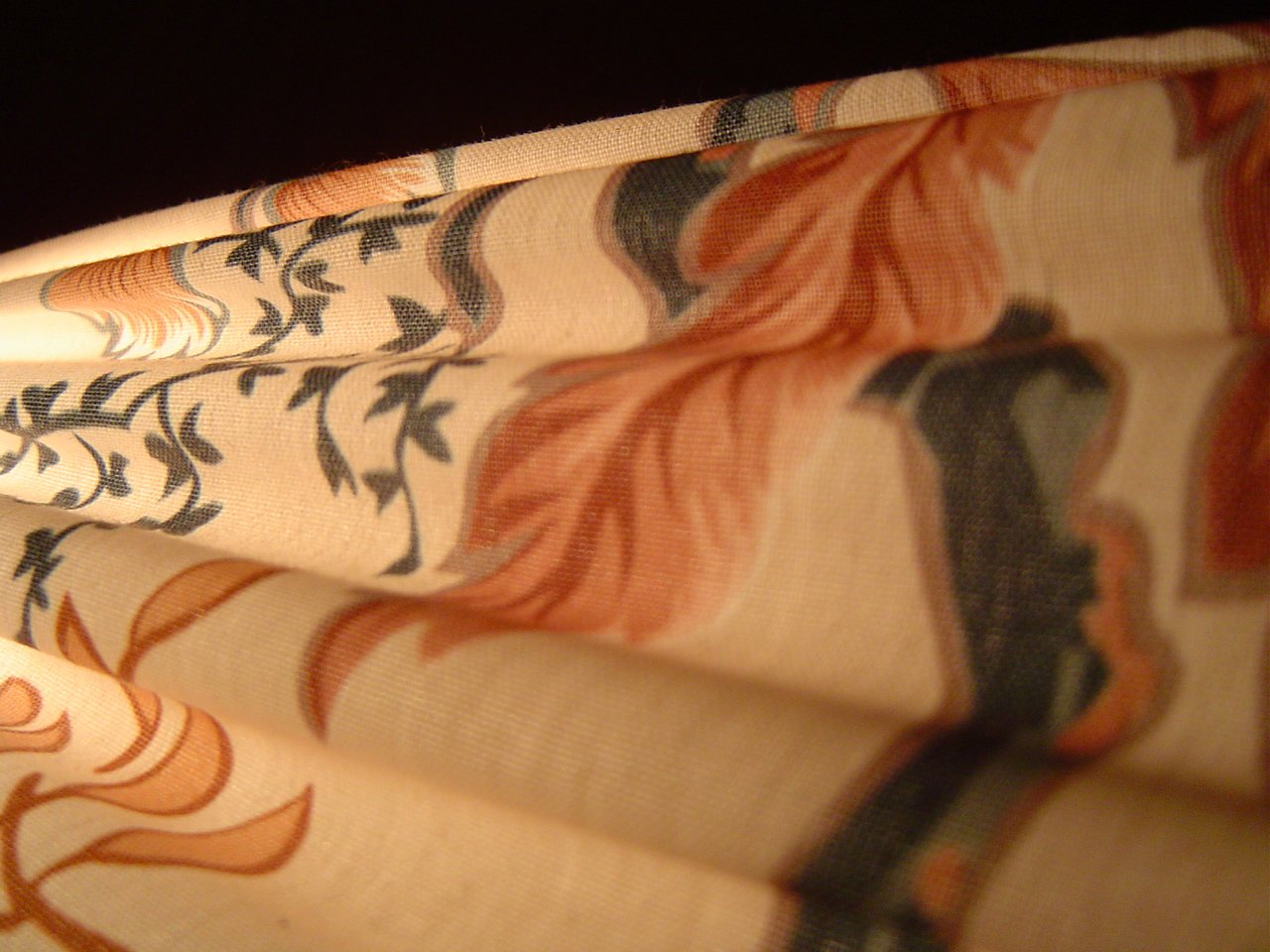 a close up of a curtain with an artistic pattern