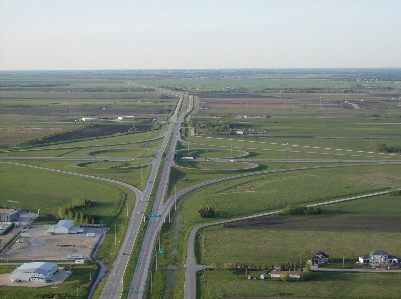 an aerial view of multiple roads through an open prairie