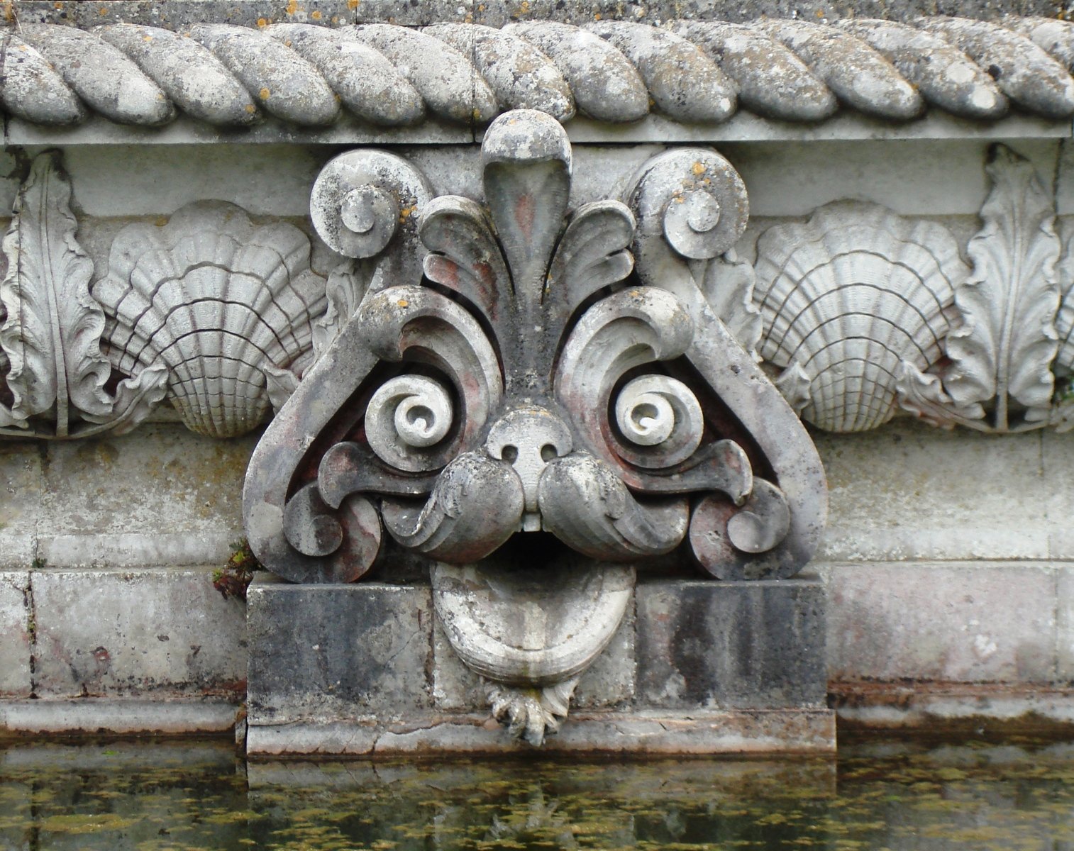 an artistic stone fountain with intricate carving