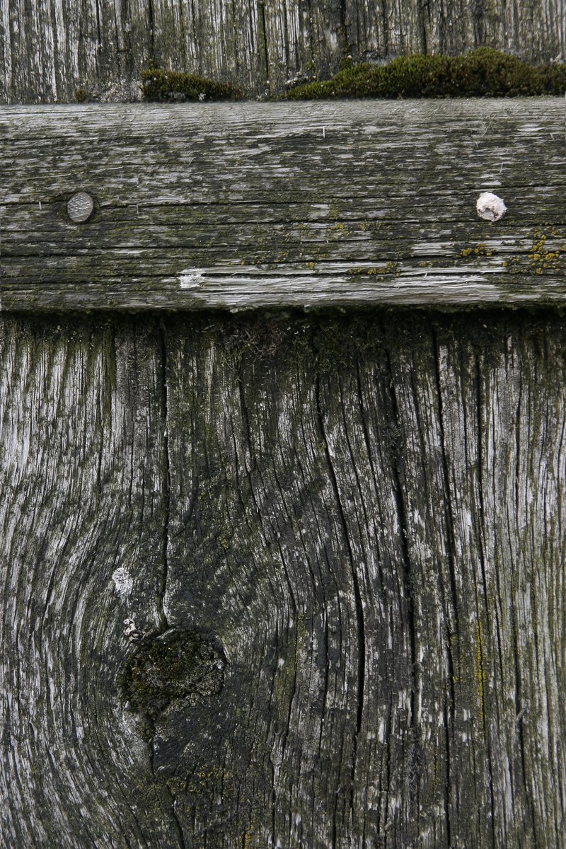 a wooden surface with planks with small holes