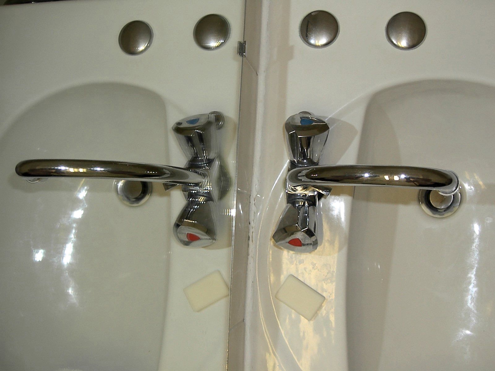 two old and modern looking sinks made of white material