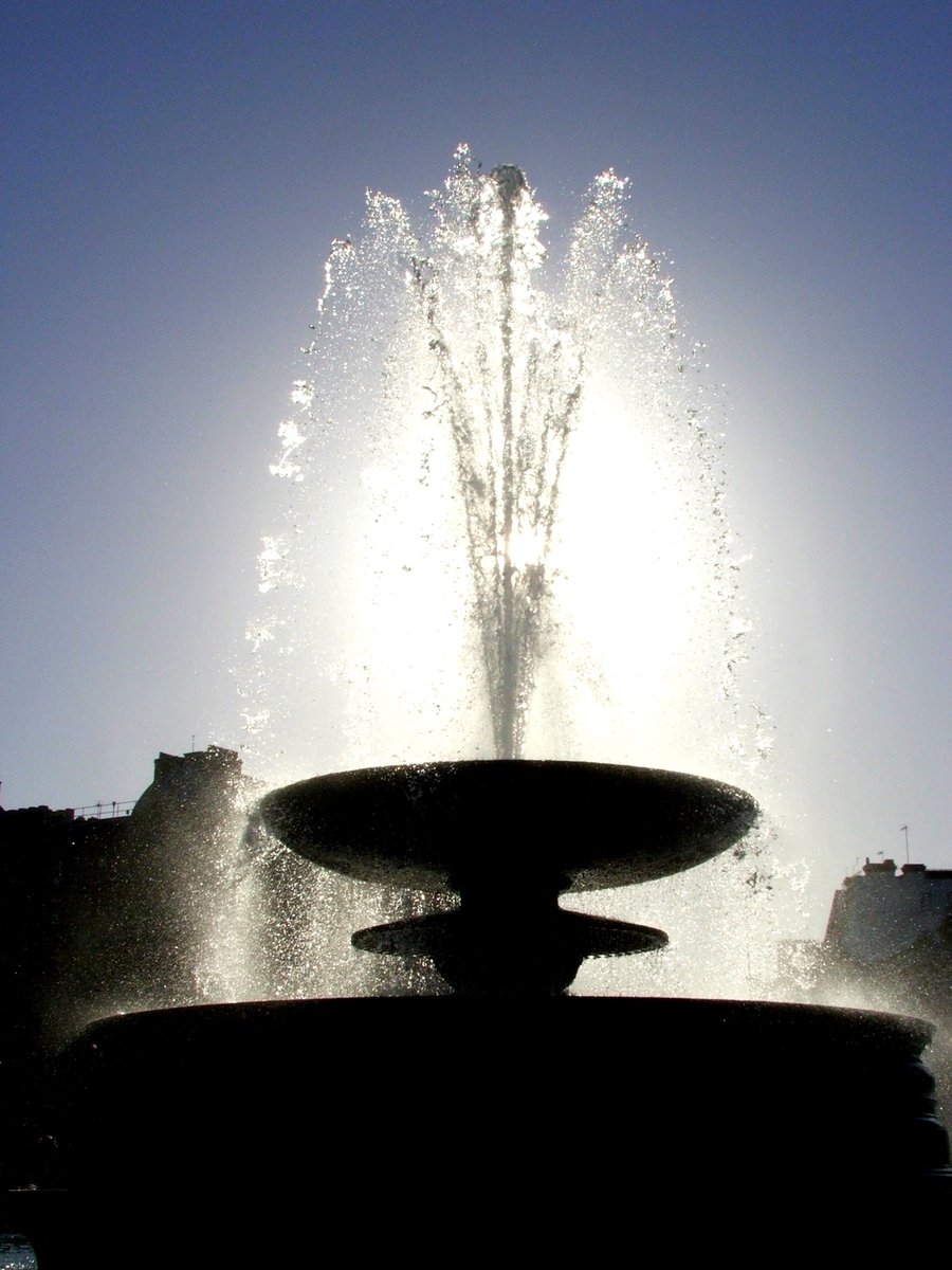 a huge fountain surrounded by water spray
