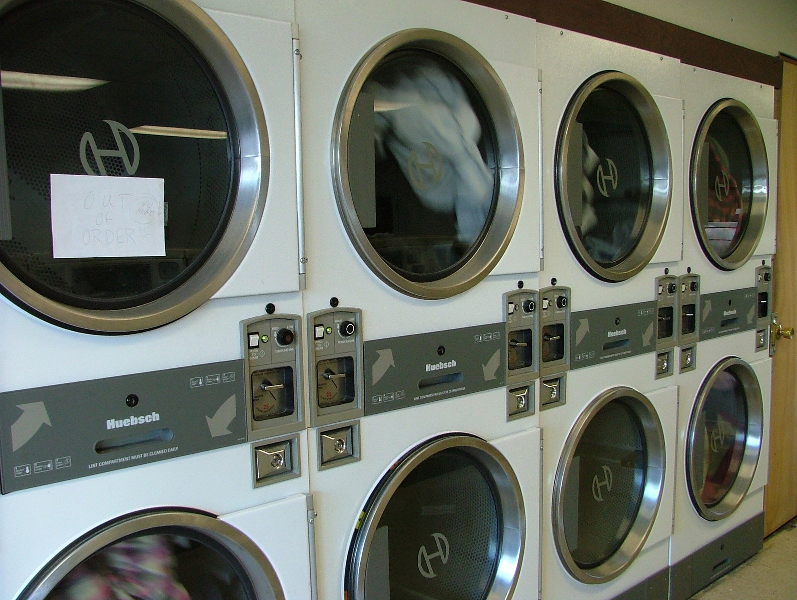 a bunch of washing machines are seen in the foreground