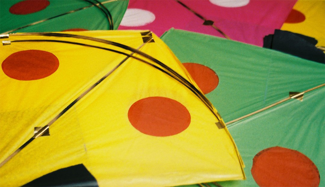 several different colored kites are shown on a table
