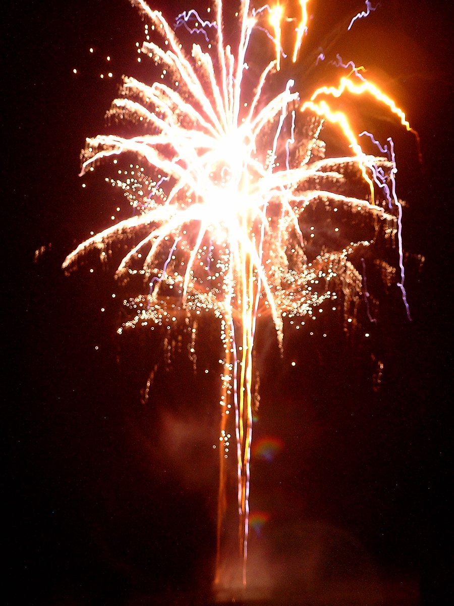 fireworks going off from one pole with bright fireworks