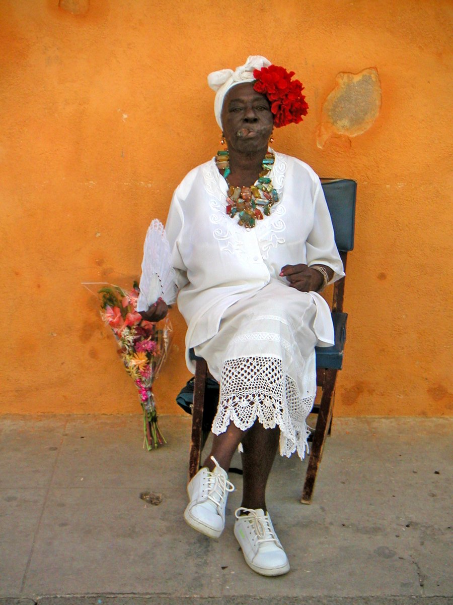 a woman is sitting in a rocking chair and posing