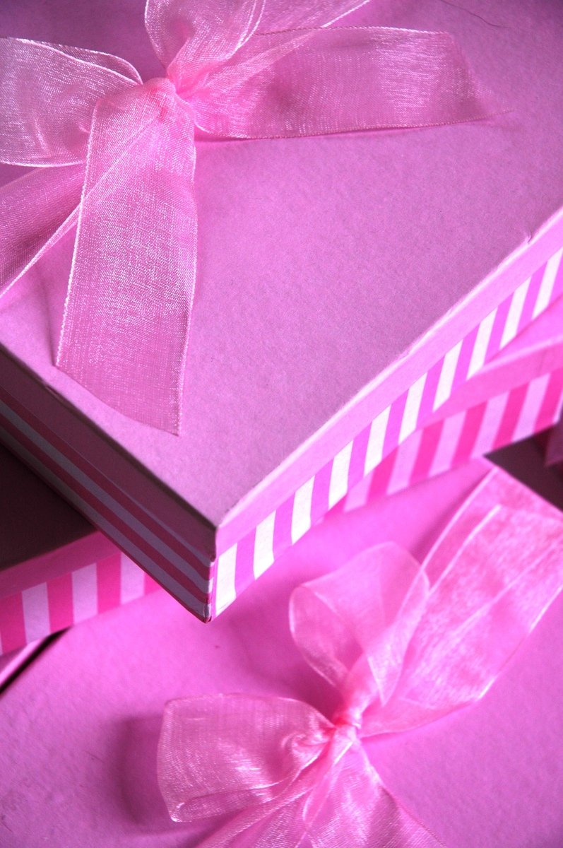 a folded pink gift card with a bow