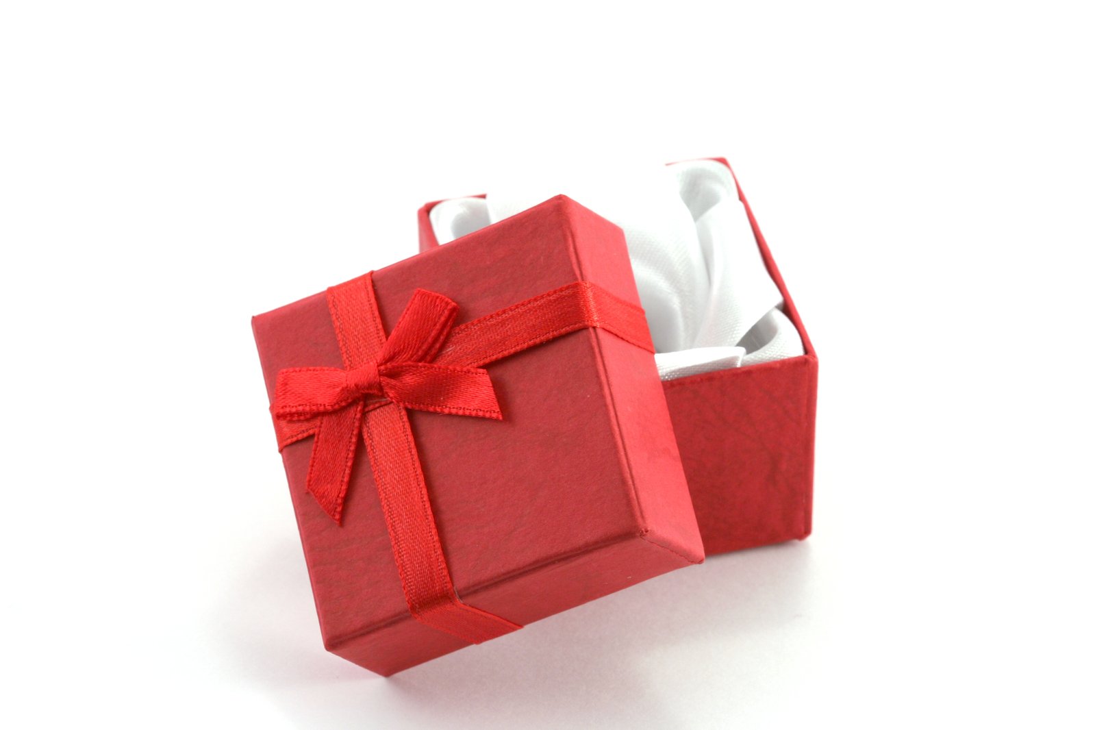 two red boxes with white tissues and a bow