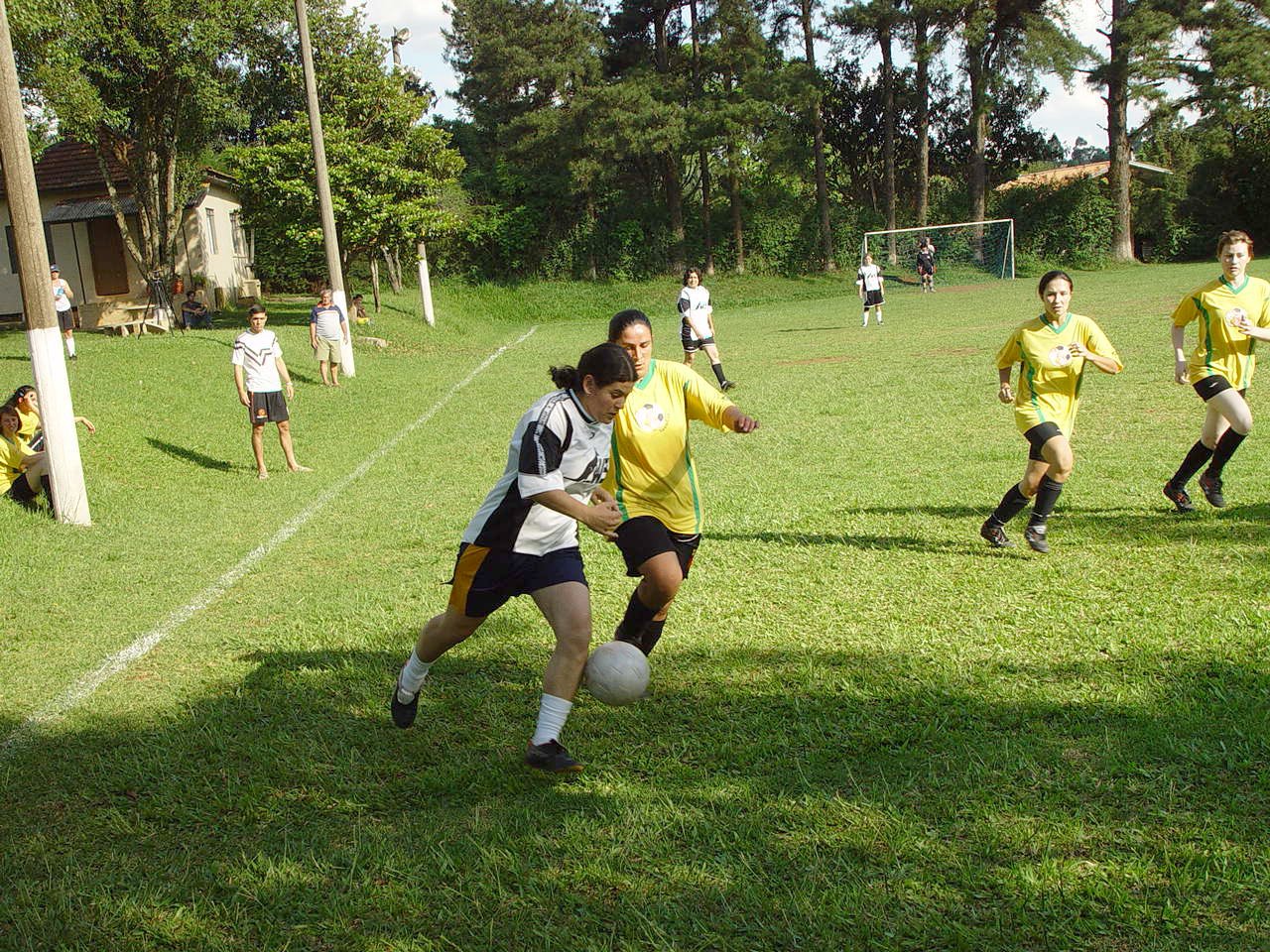 a group of young people kicking around a soccer ball