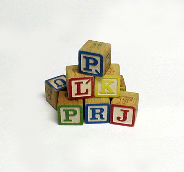 three blocks spelling phonics are arranged to spell out the word pru