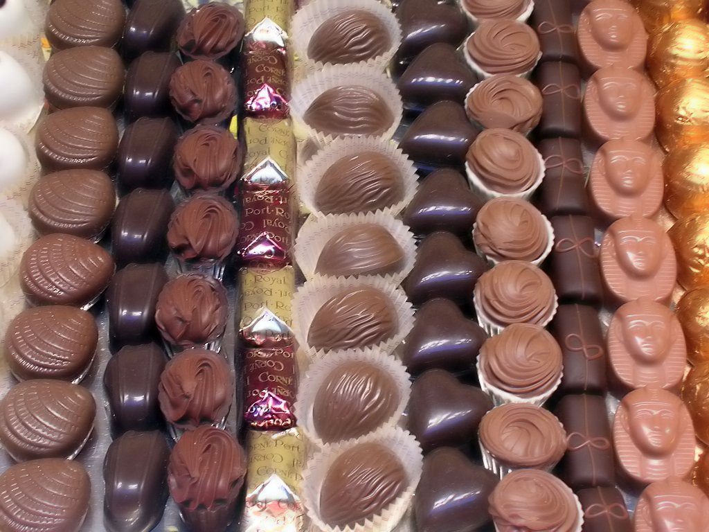 an assortment of chocolates displayed on top of each other