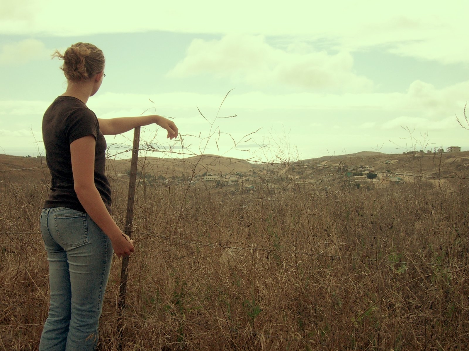 a person standing in the middle of a field