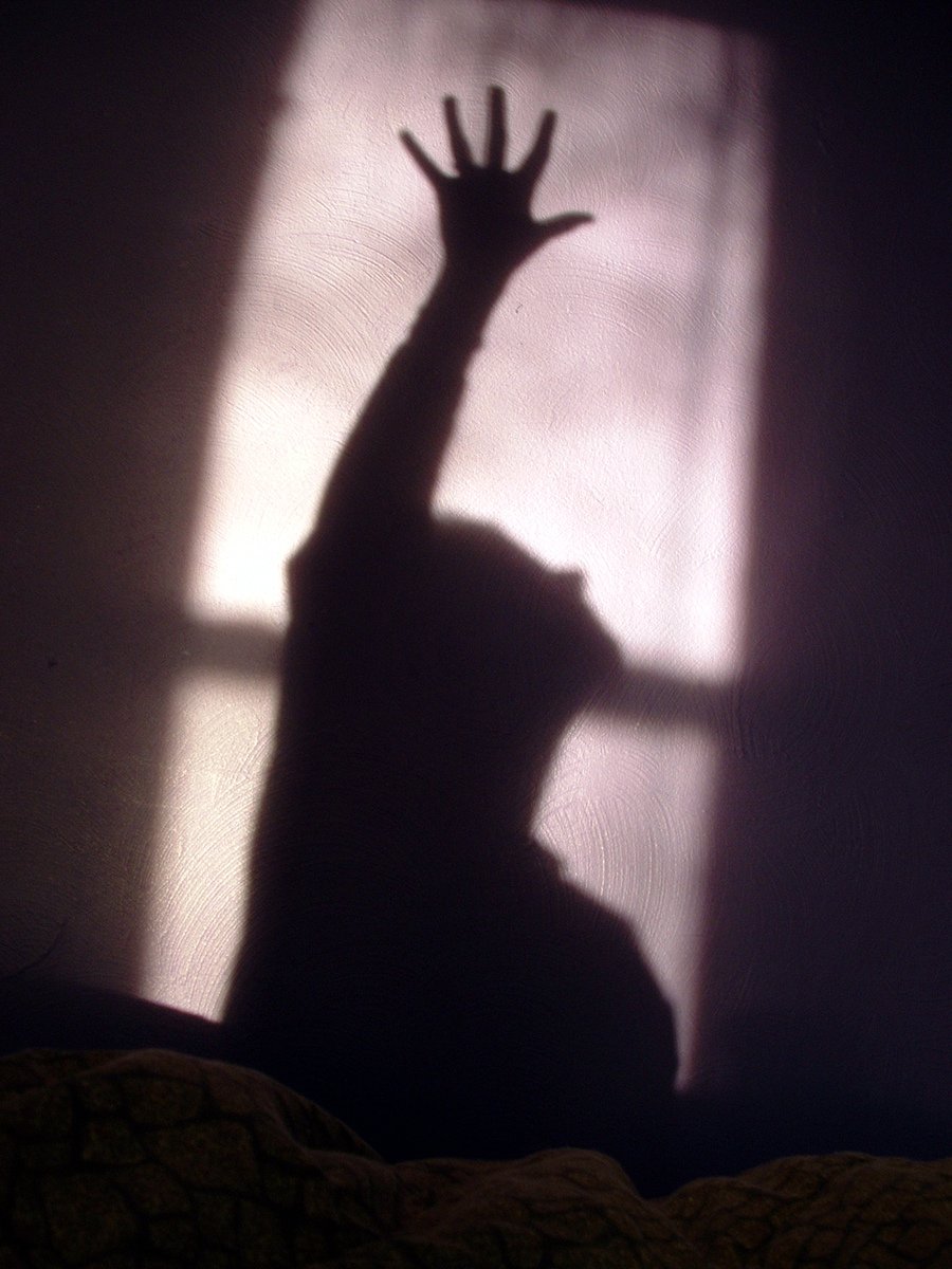 a person is reaching their hands up towards the sun