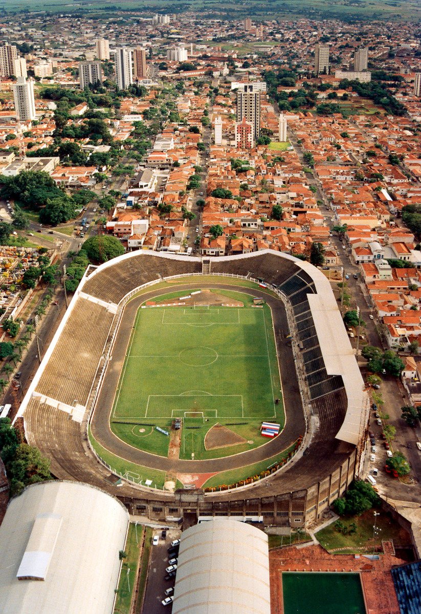 an aerial view of a large sports field and city