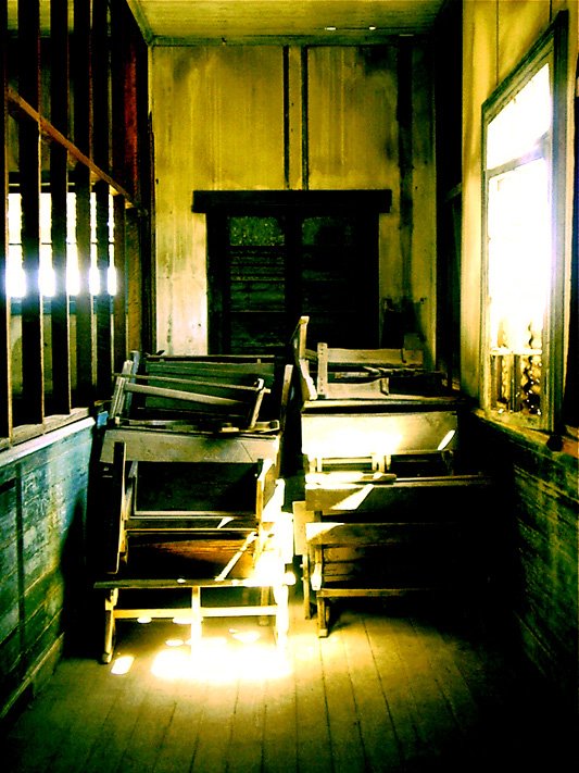 several empty benches next to a window in an empty building