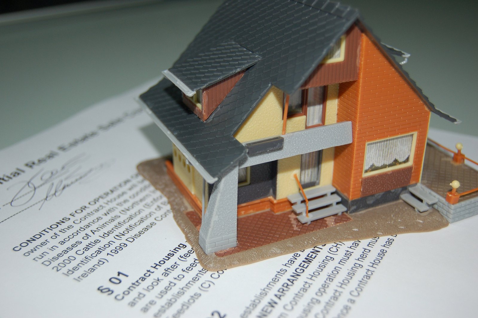 a paper house on top of an open book