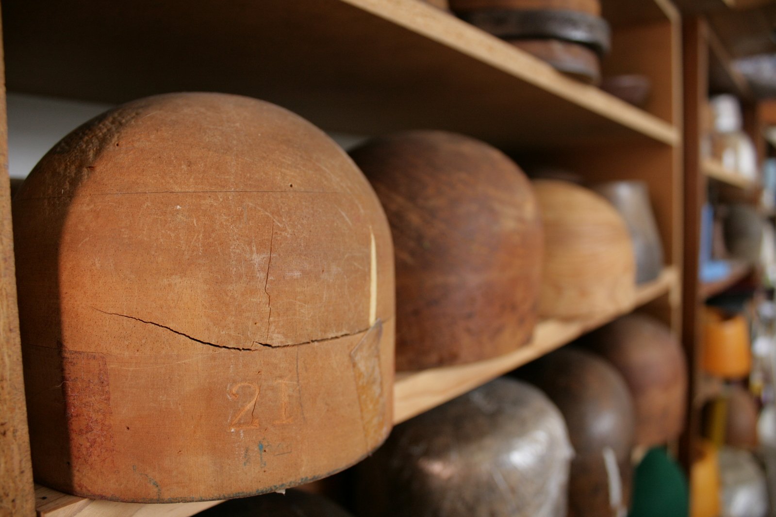 a bunch of old pottery on some shelves