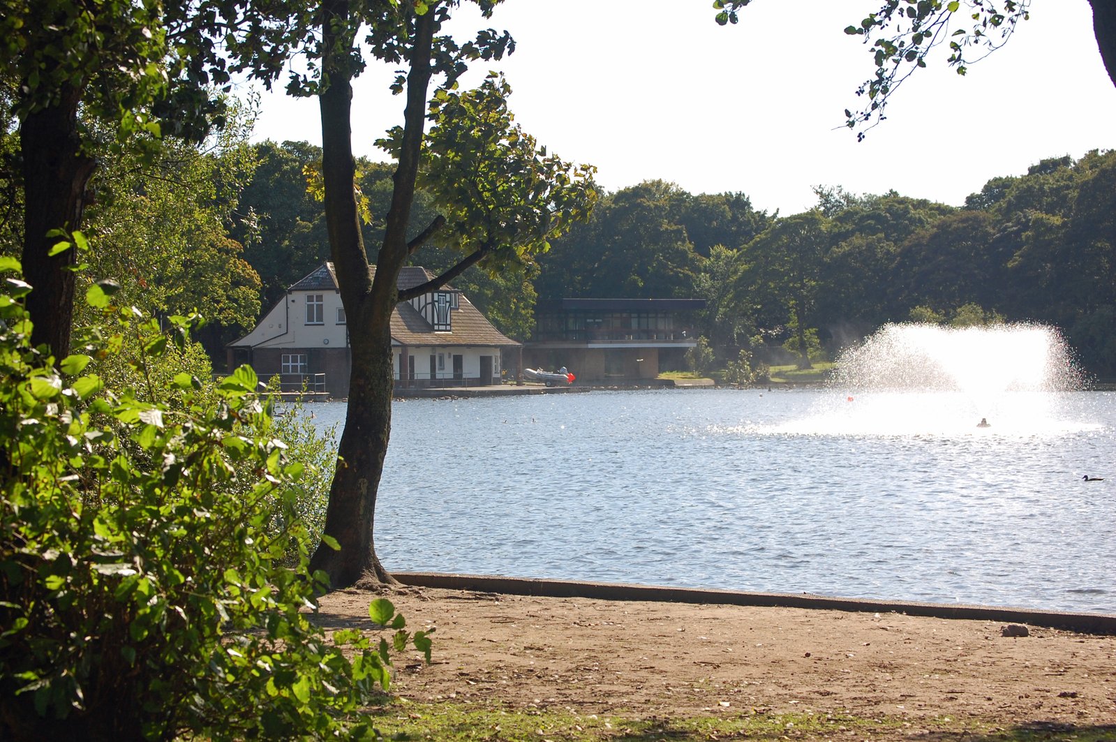 two people are swimming in the water near a house