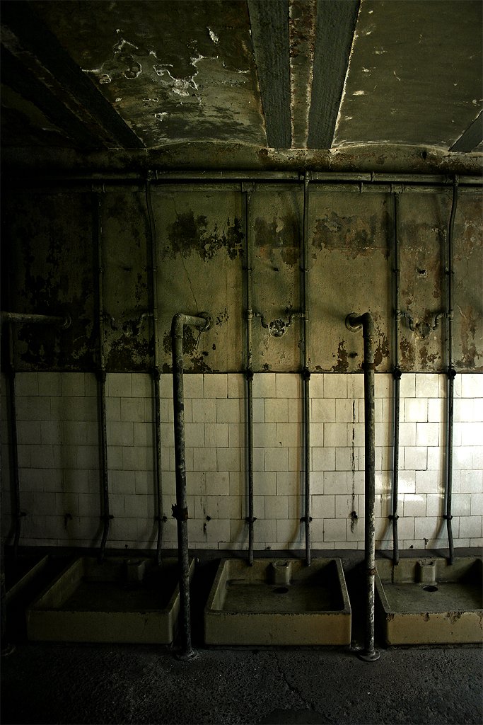 a room with several urinals on the wall