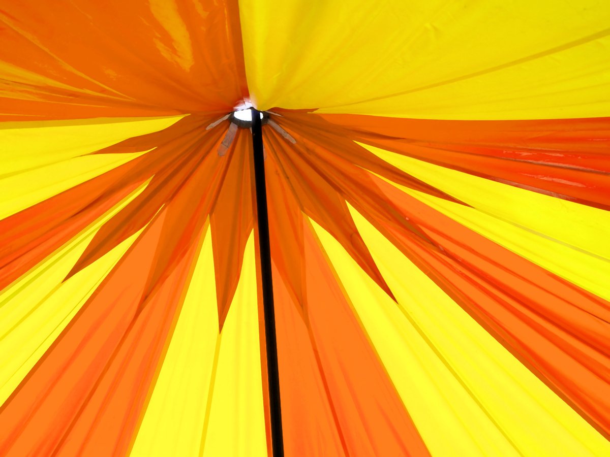 a yellow and red colored umbrella close up