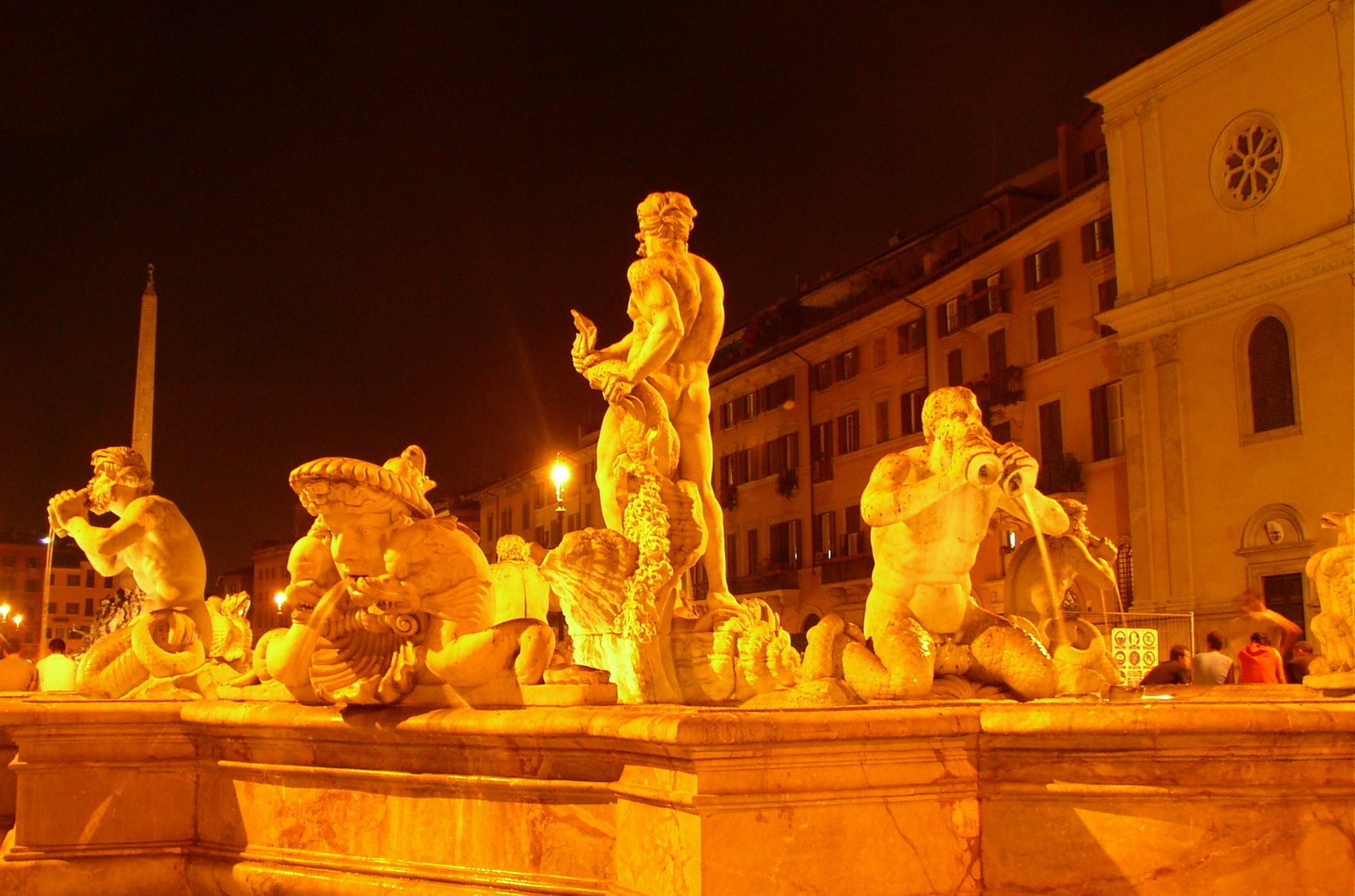 a fountain that is surrounded by some statues