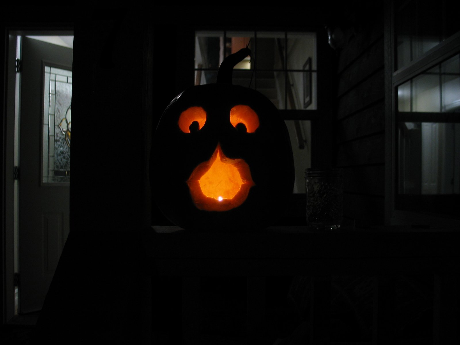 a carved pumpkin sitting on top of a window sill
