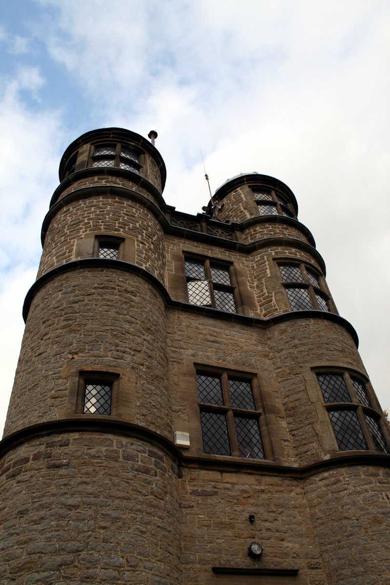 a large stone tower with two windows on the side