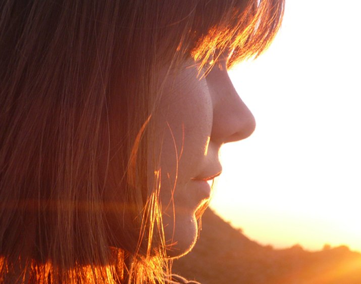 a person with red hair staring into the distance