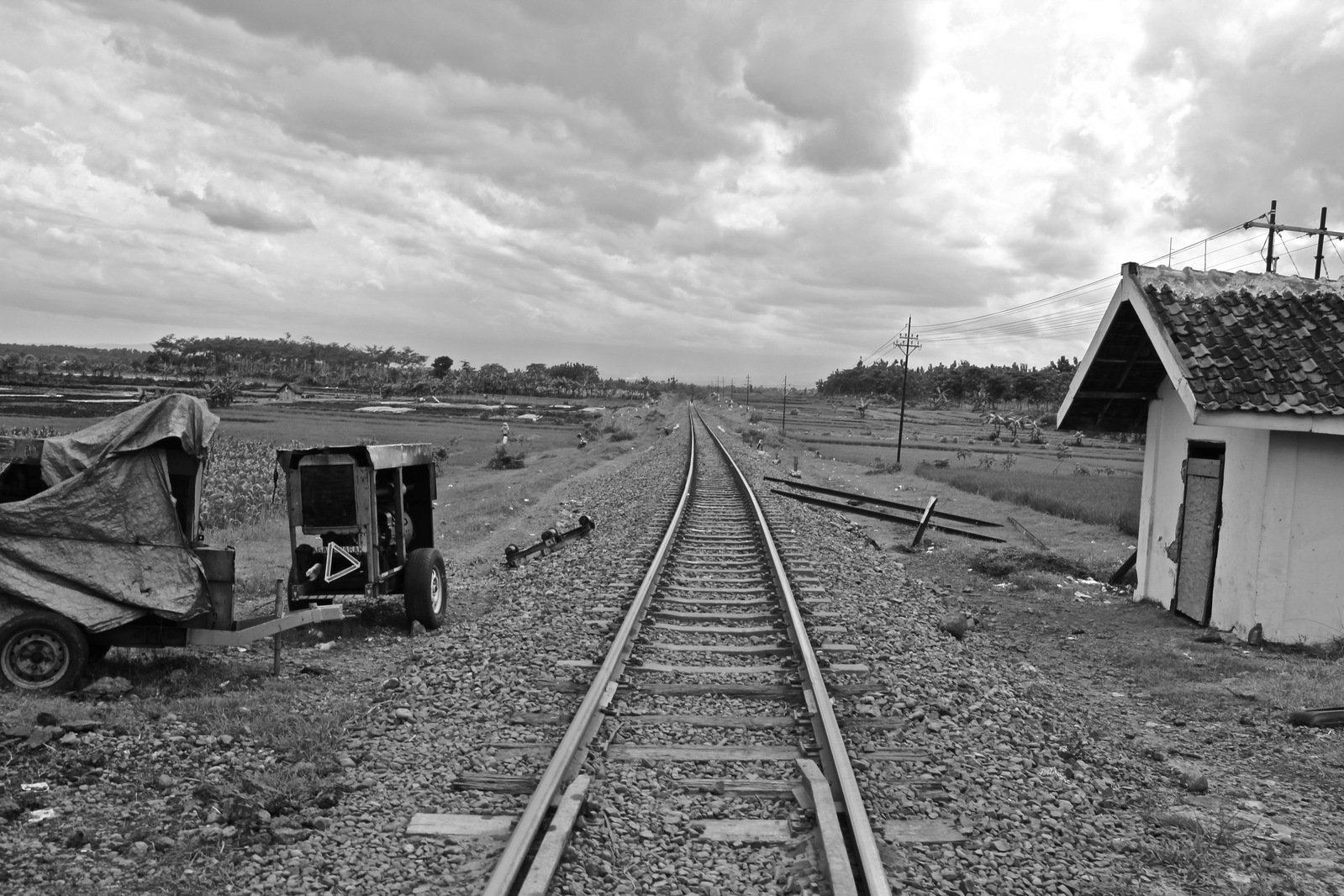 the view of an abandoned railroad station from the tracks