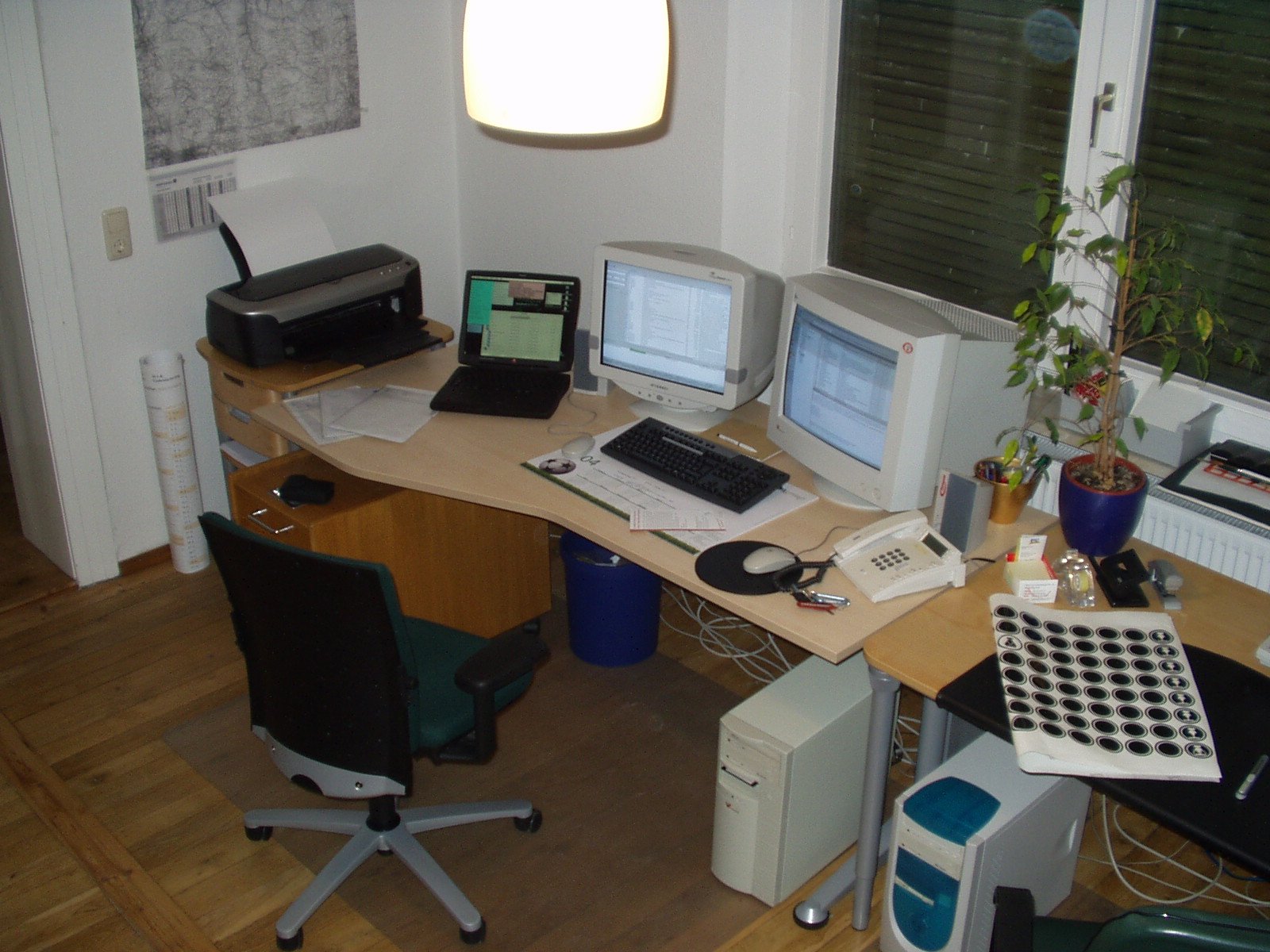 a desk with computers and other equipment sitting on it