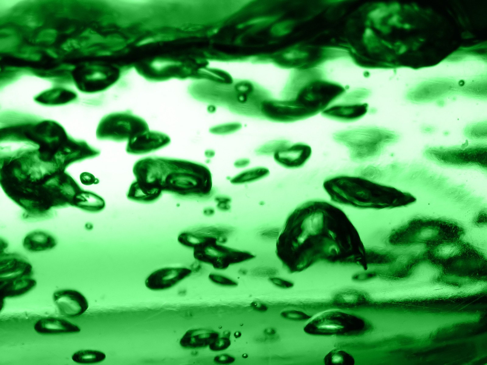 drops of green colored liquid in a cup