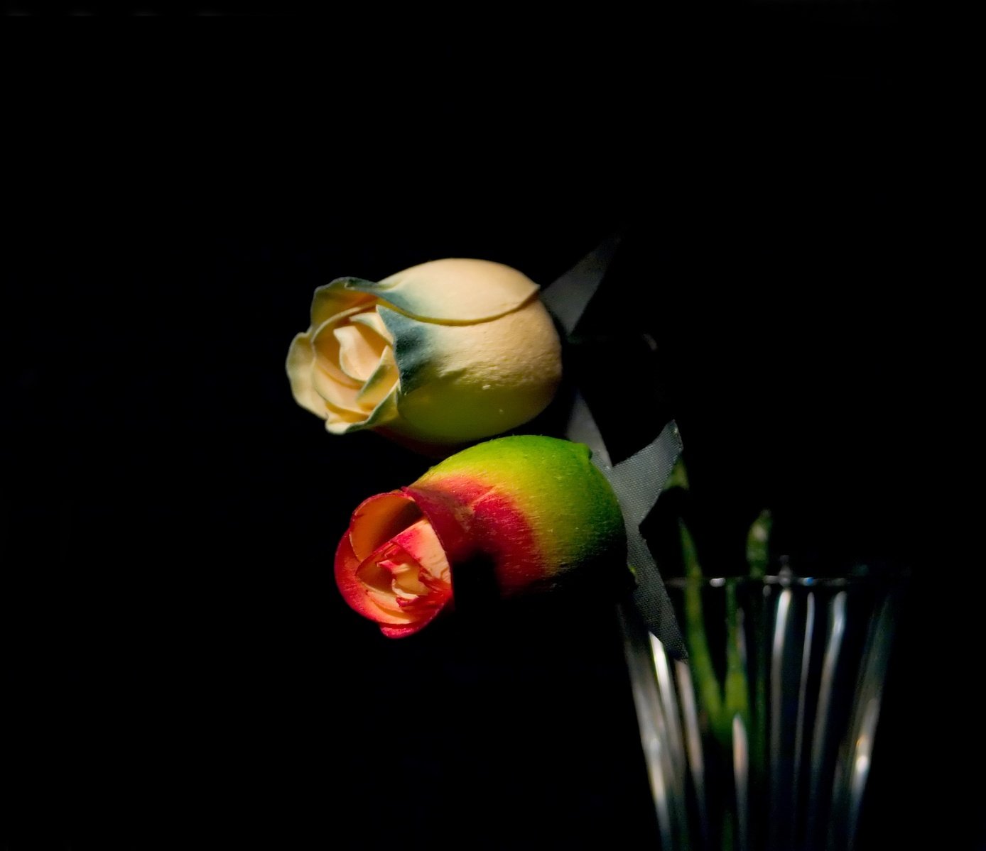 a flower with a stem in a glass vase