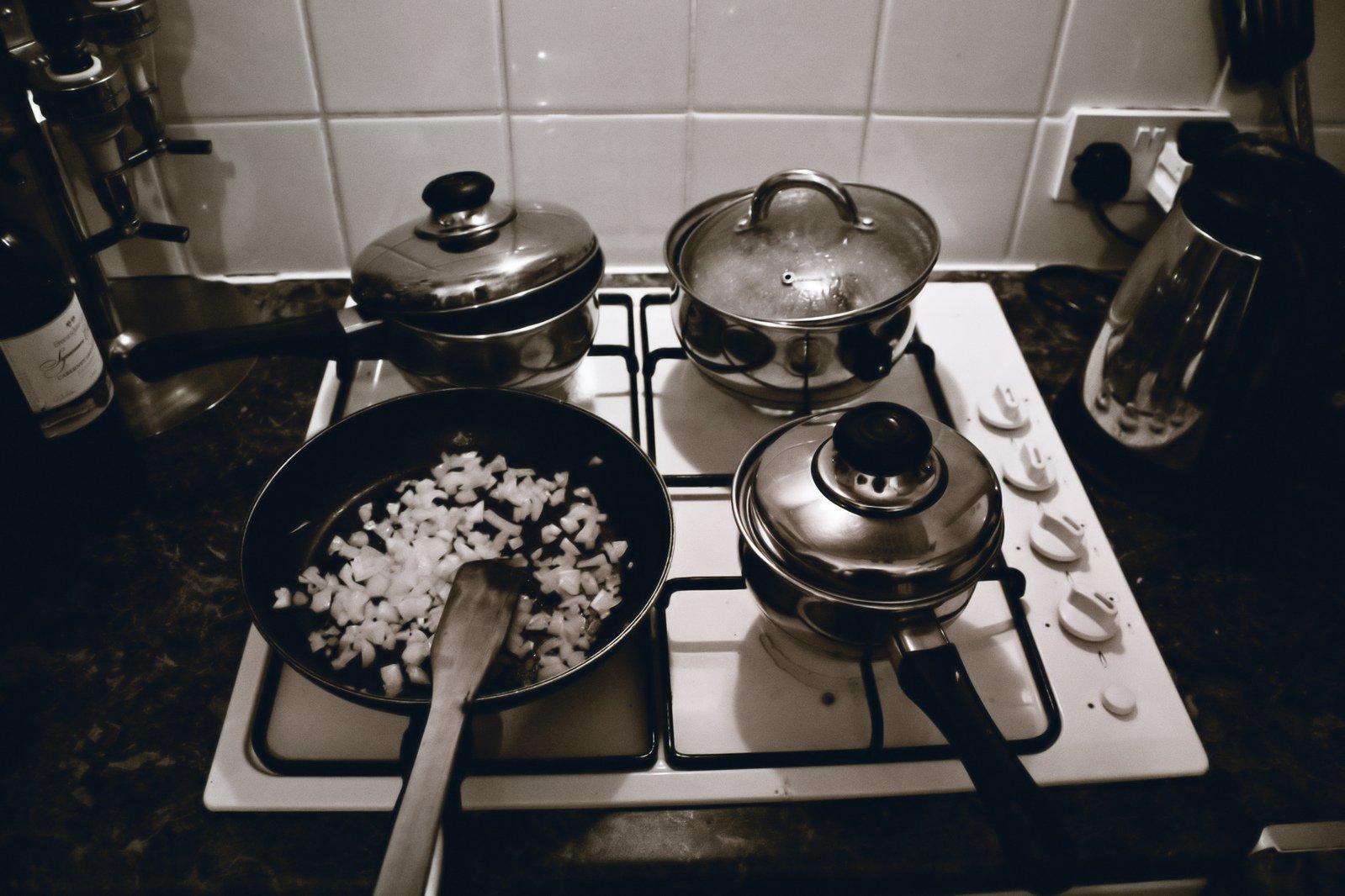 a stove with two pans and a stove top