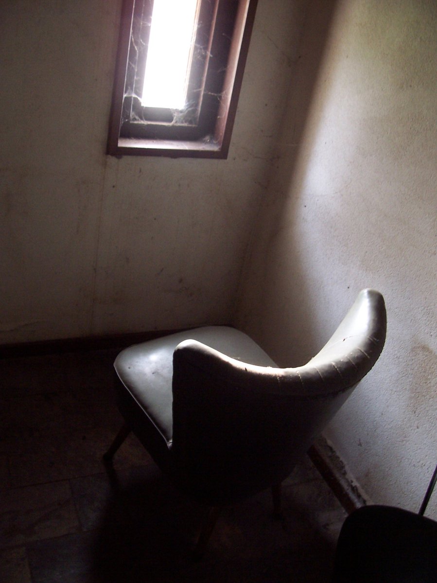 a chair sitting in the corner of a room