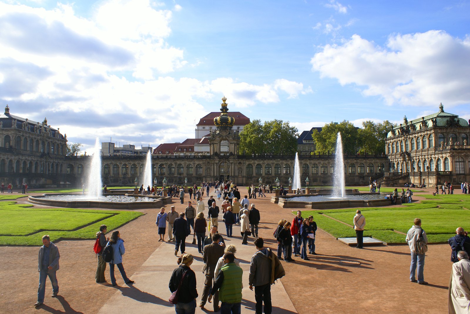 many people are in front of the building and fountain